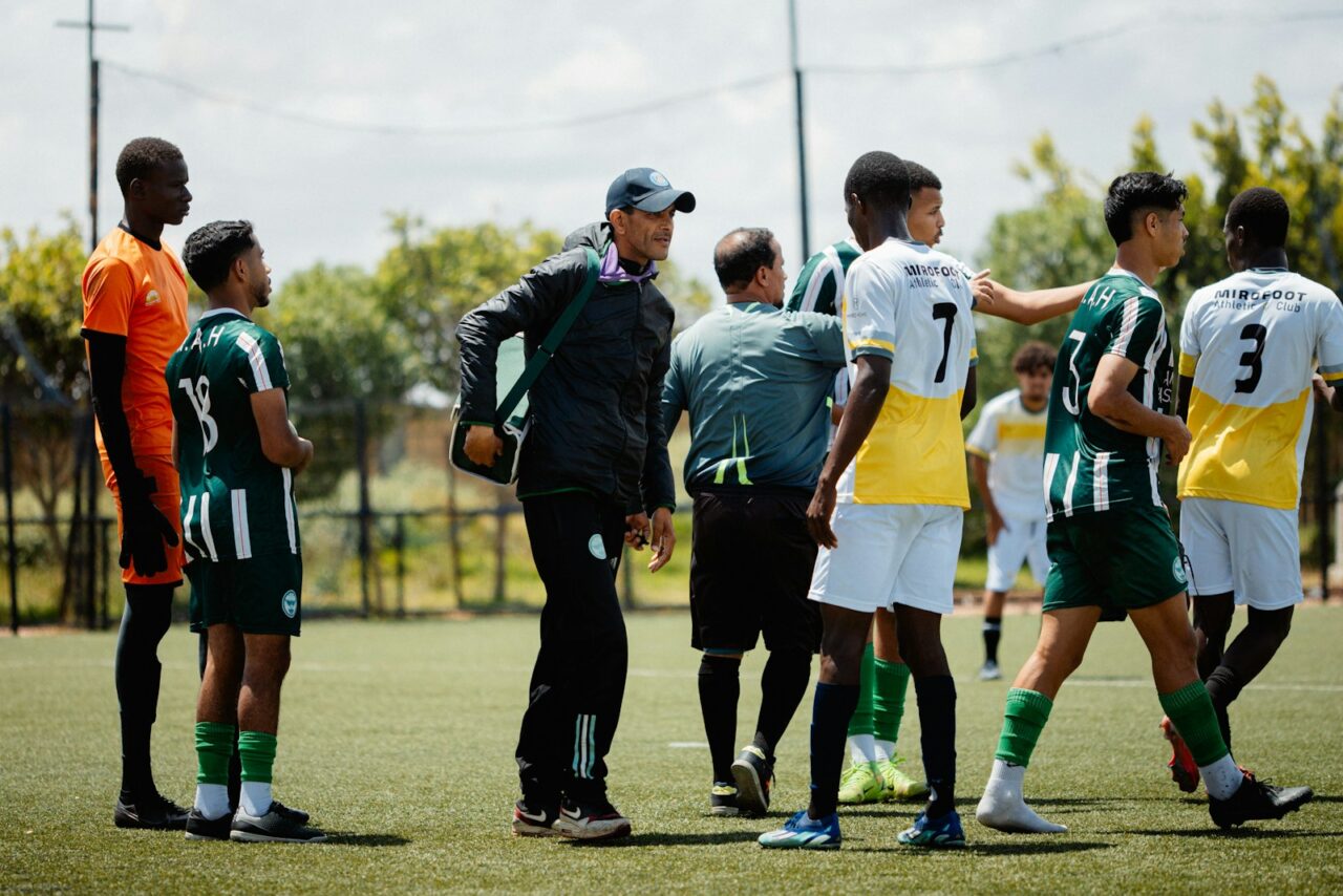 Soccer coach gives instructions to his team.