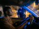A calm driver keeps hands on the steering wheel during a nighttime traffic stop in Nigeria.